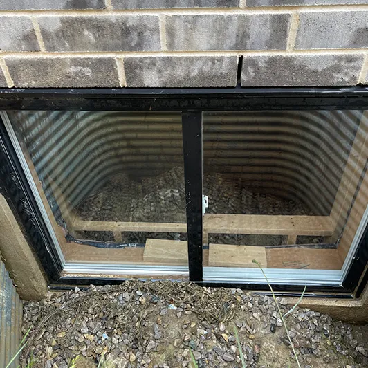 The same basement window exterior after cleaning