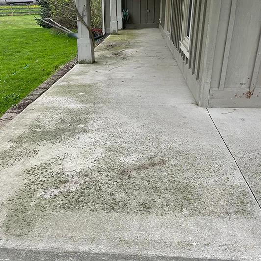 Stained concrete porch before pressure washing