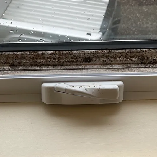 Window sill caked with dirt before cleaning